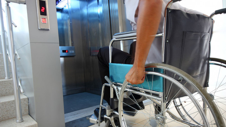 Man in a wheelchair entering a lift