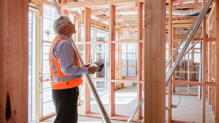 Builder marking out a timber saw-line