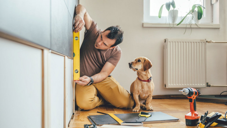 Builder checking interior wall is level