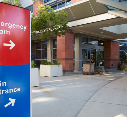 Main entrance to a hospital building with signs