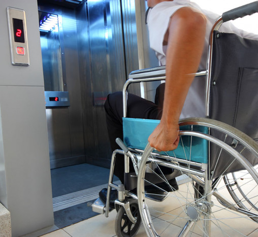 Man in a wheelchair entering a lift