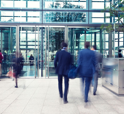 People entering and leaving a building