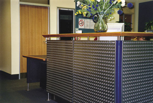 A high reception counter with the accessible section around the corner A high reception counter with the accessible section around the corner