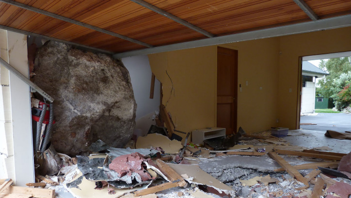 Large rock crashed through garage wall