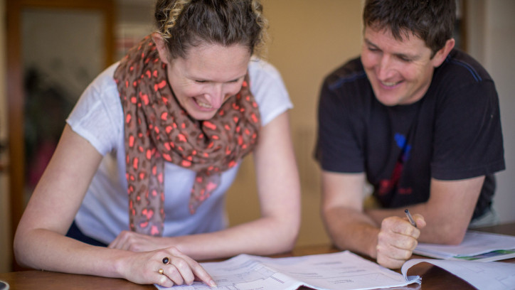 Homeowner discussing house plans with her builder