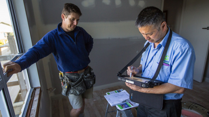 Building inspector working with a builder