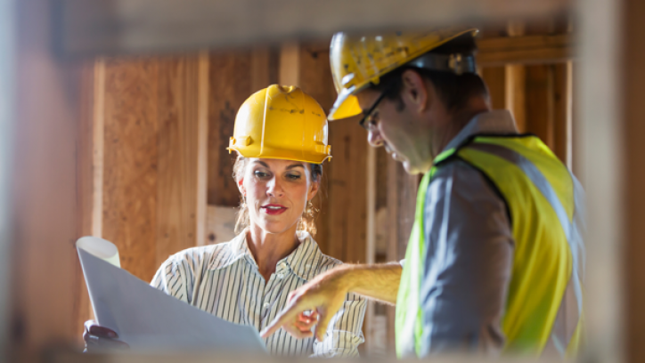 Two building professionals discuss design plans