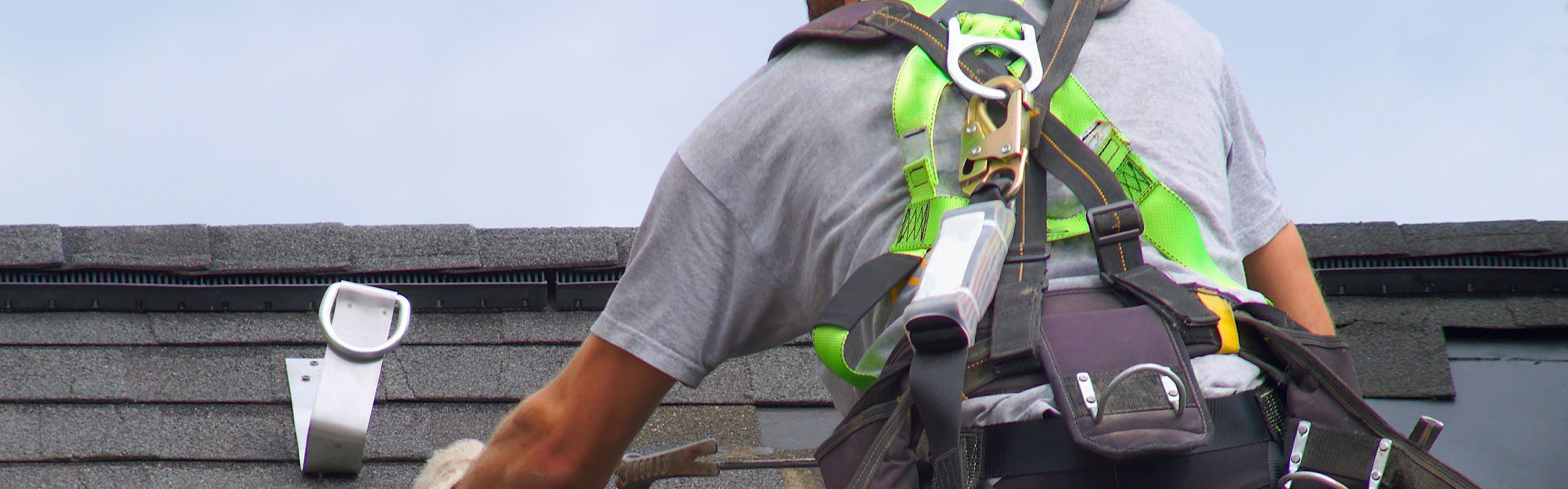 Roofer in safety harness