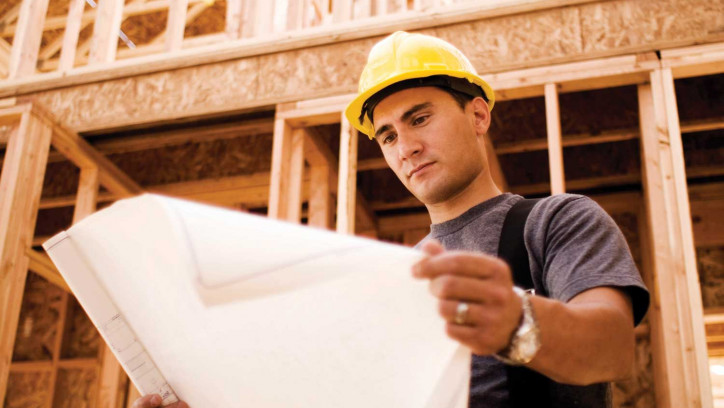 Construction worker looking at plans