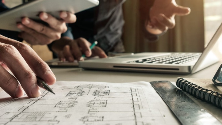 Two people examining building plans