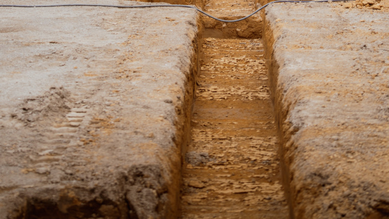 Shallow foundation trench excavated in compacted soil.