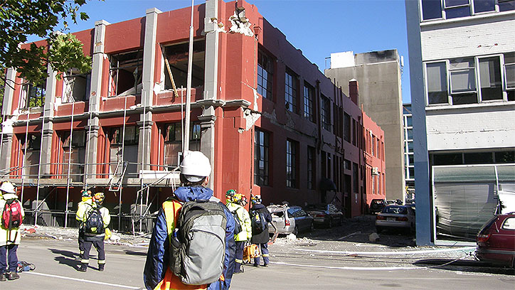 Assessors looking at earthquake damaged building