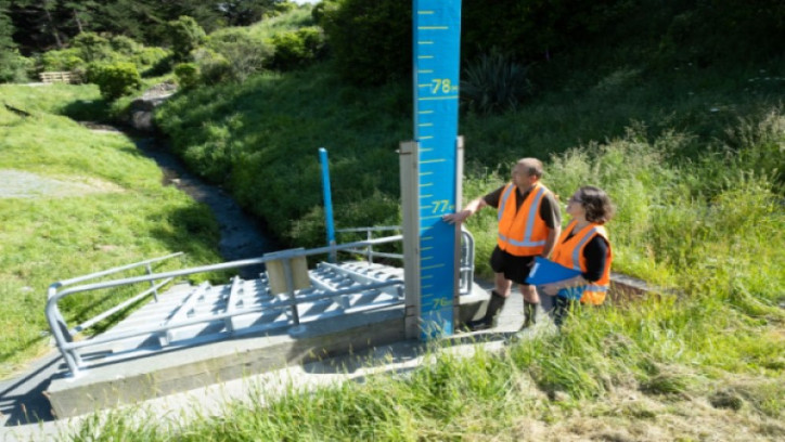 Two engineers inspecting an outlet structure
