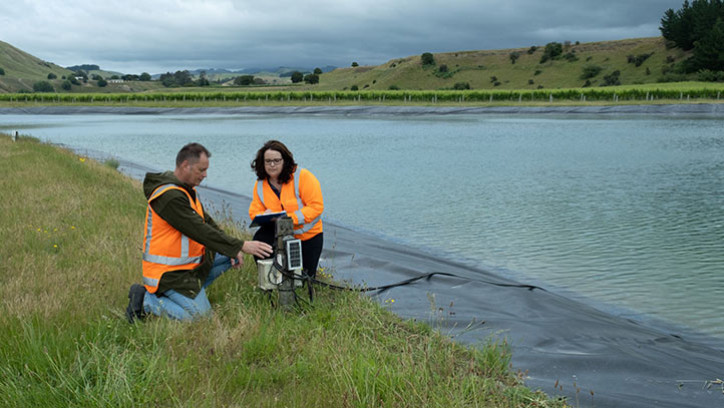 People  monitoring a dam.