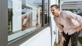 Man examines double-glazed windows