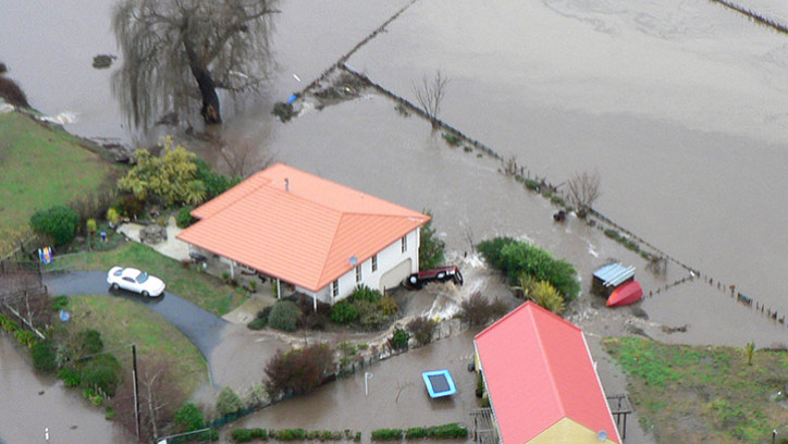 Farm houses surrounded by flood waters